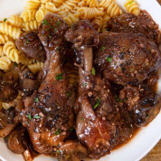 Red Wine Braised Legs with Mushrooms serving on plate with rotini pasta