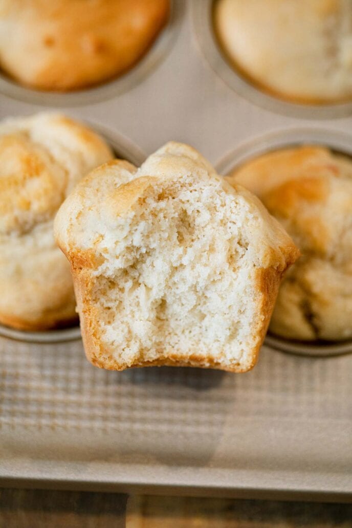 Beer Bread Muffins muffin with bite removed in muffin tin