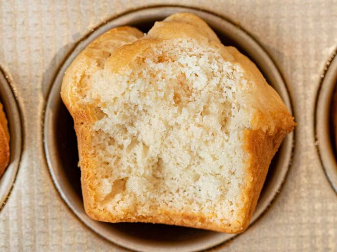 Beer Bread Muffins muffin with bite removed in muffin tin