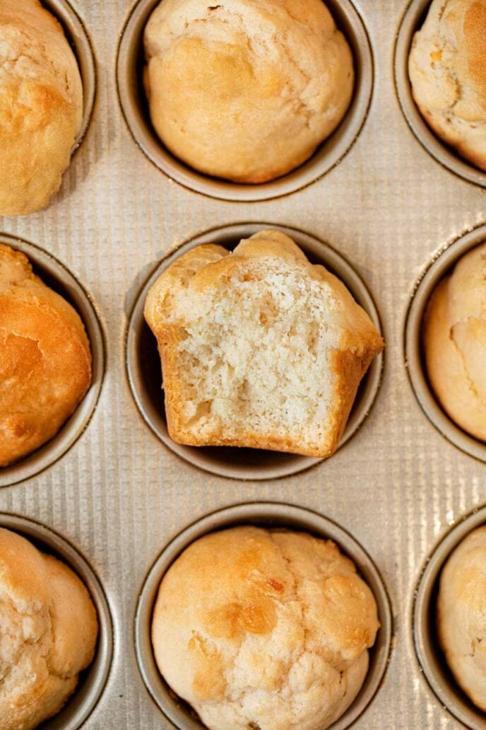 Beer Bread Muffins muffin with bite removed in muffin tin