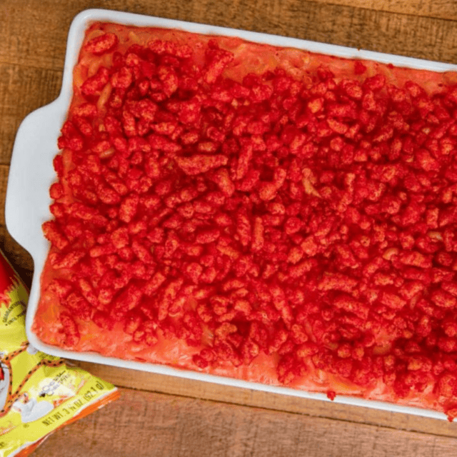 dish of baked pasta with bag of cheetos on side