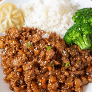 Chicken served on plate with rice and broccoli