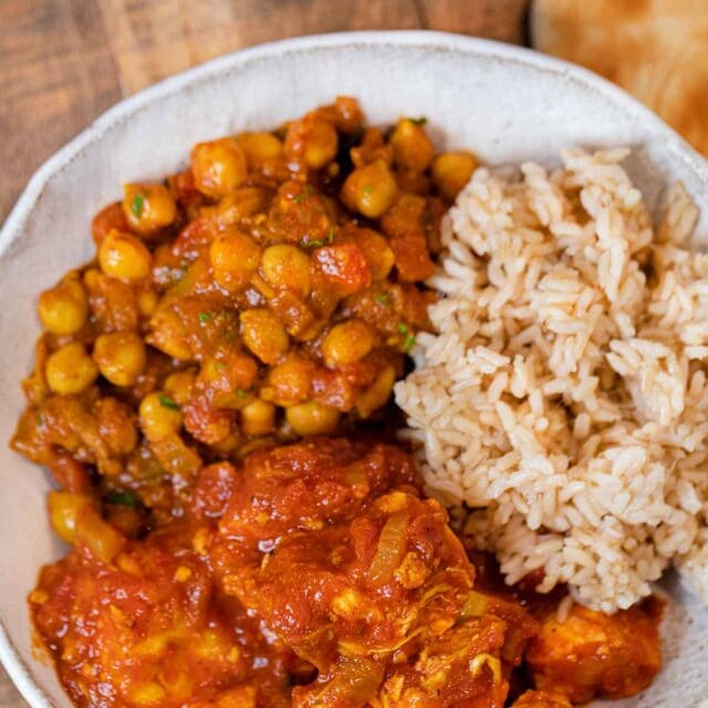 Indian Tomato Chicken in bowl with chickpeas and rice