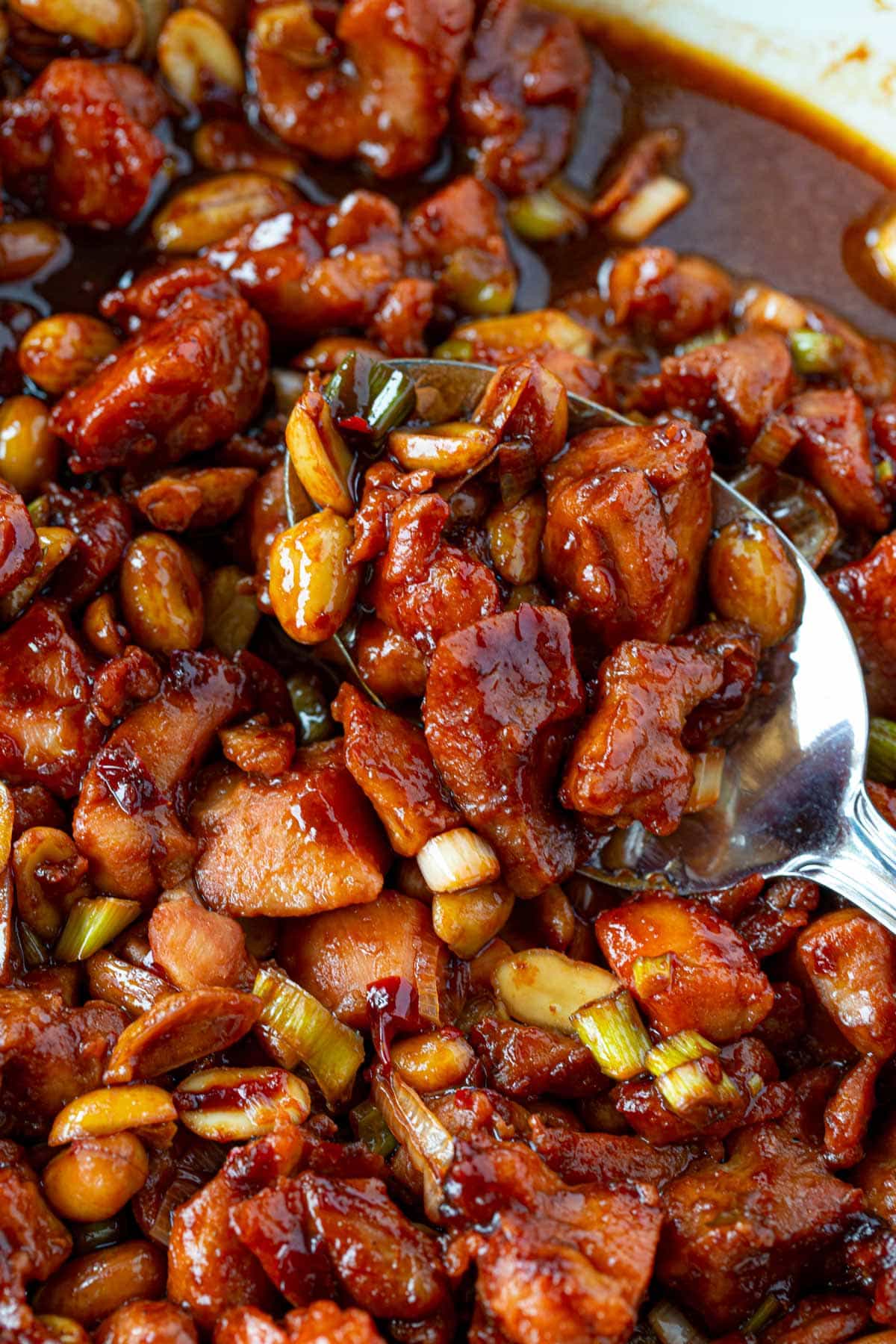Spoonful of Kung Pao Chicken in pan