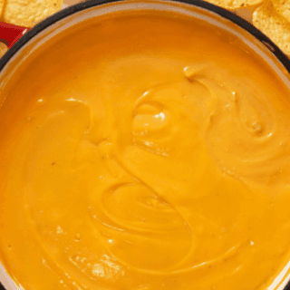 Melted cheese sauce in red pot