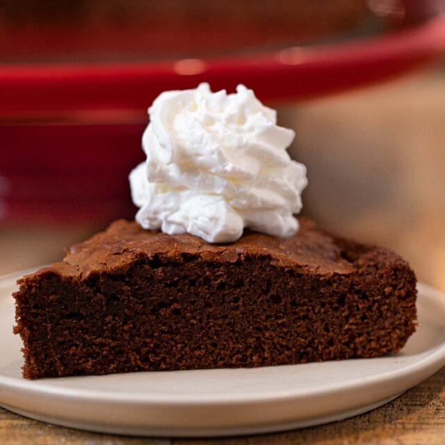 Nutella Cake slice on plate with whipped cream topping