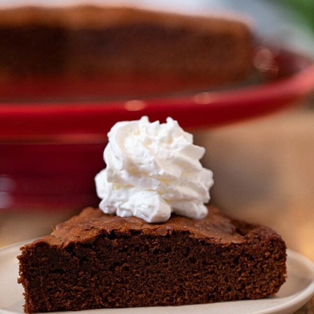Nutella Cake slice on plate with whipped cream topping