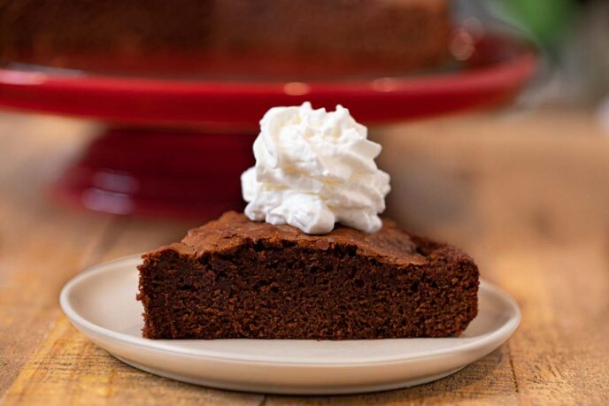 Nutella Cake slice on plate with whipped cream topping