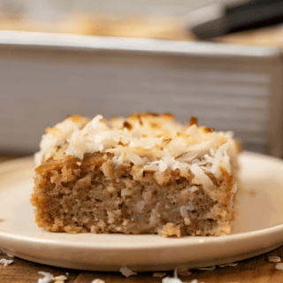 slice of sweet oat cake with coconut on white plate