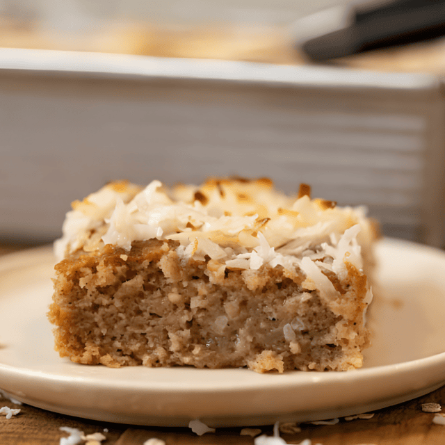 slice of sweet oat cake with coconut on white plate