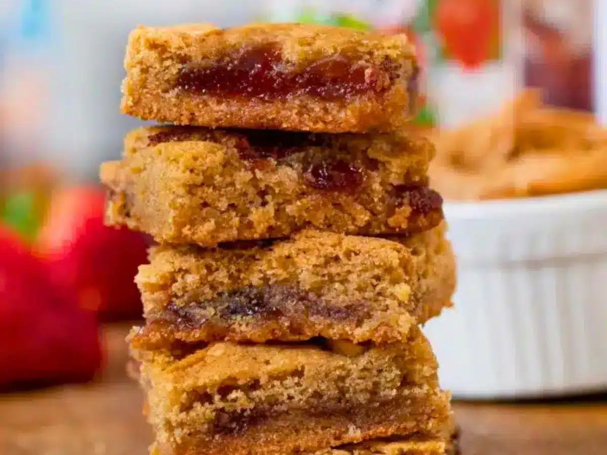 Stack of blondies with strawberries in the background