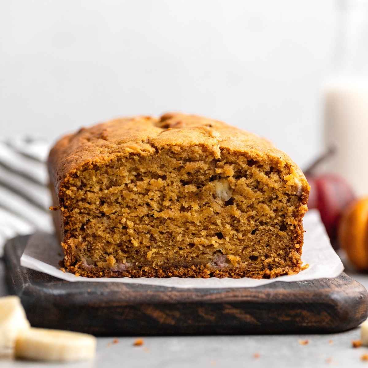 Pumpkin banana bread served on cutting board.