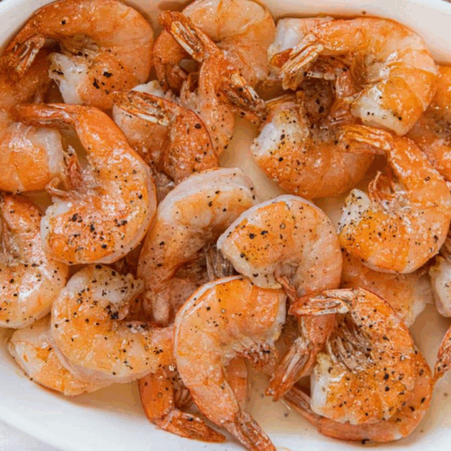 Several shrimp on a white serving platter