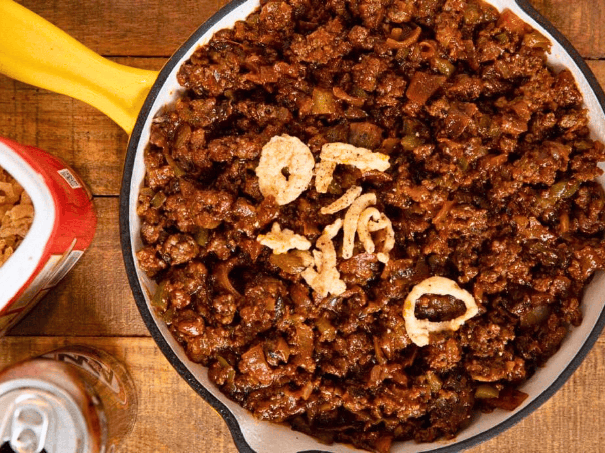Pan full of meat mixture with crispy onions on top