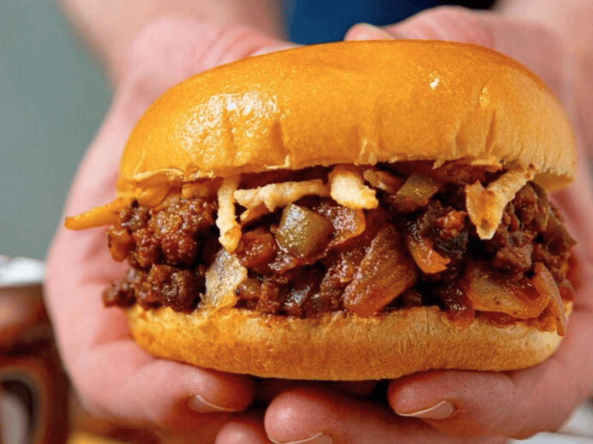 Hands holding sandwich