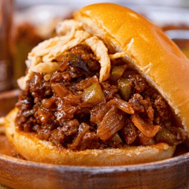 Bun sliding off top of meat mixture sandwich
