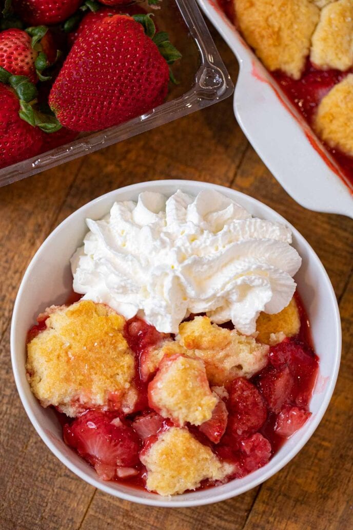 Strawberry Cobbler in bowl with whipped cream