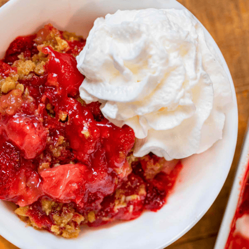 glazed strawberries, oats, and whipped cream in a bowl