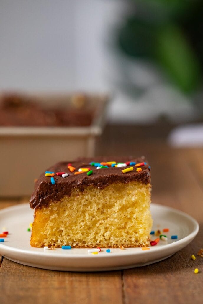 Yellow Sheet Cake with Chocolate Frosting slice on plate