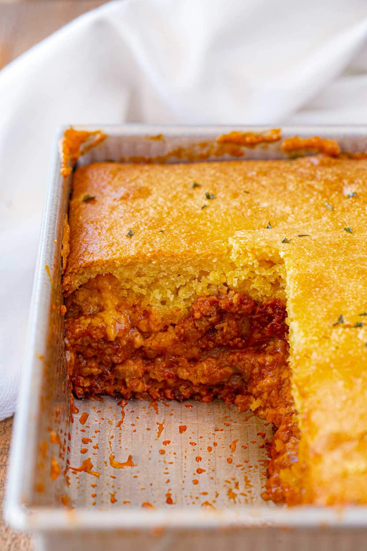 cross-section of BBQ Chicken Cornbread Casserole in baking pan