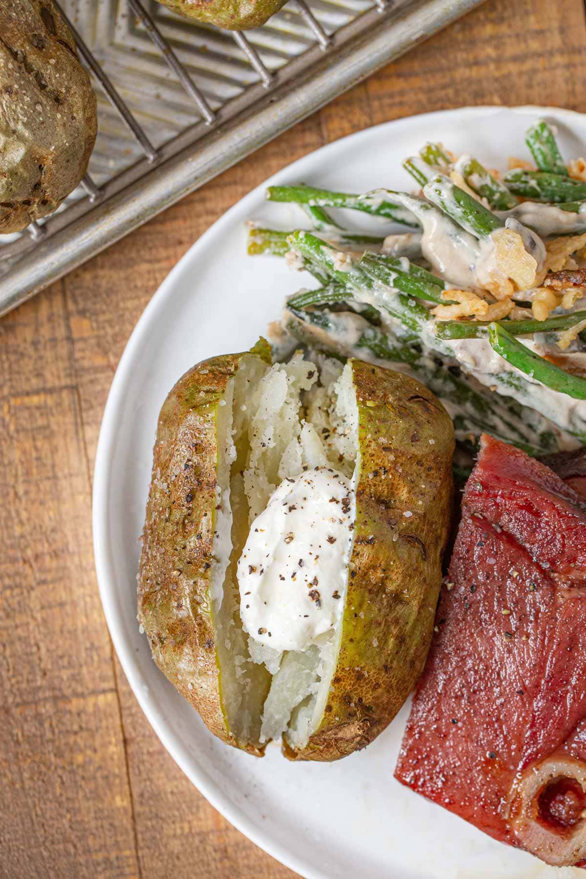 Baked Potato with sour cream on plate