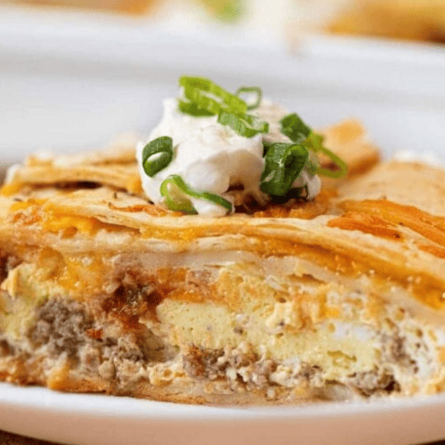 burrito casserole with sour cream on top