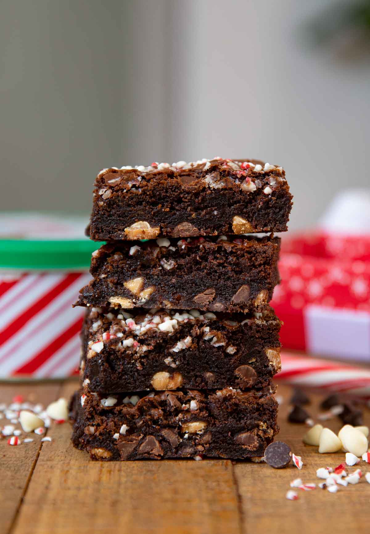 Candy Cane Brownies with white chocolate and chocolate chips on board around it