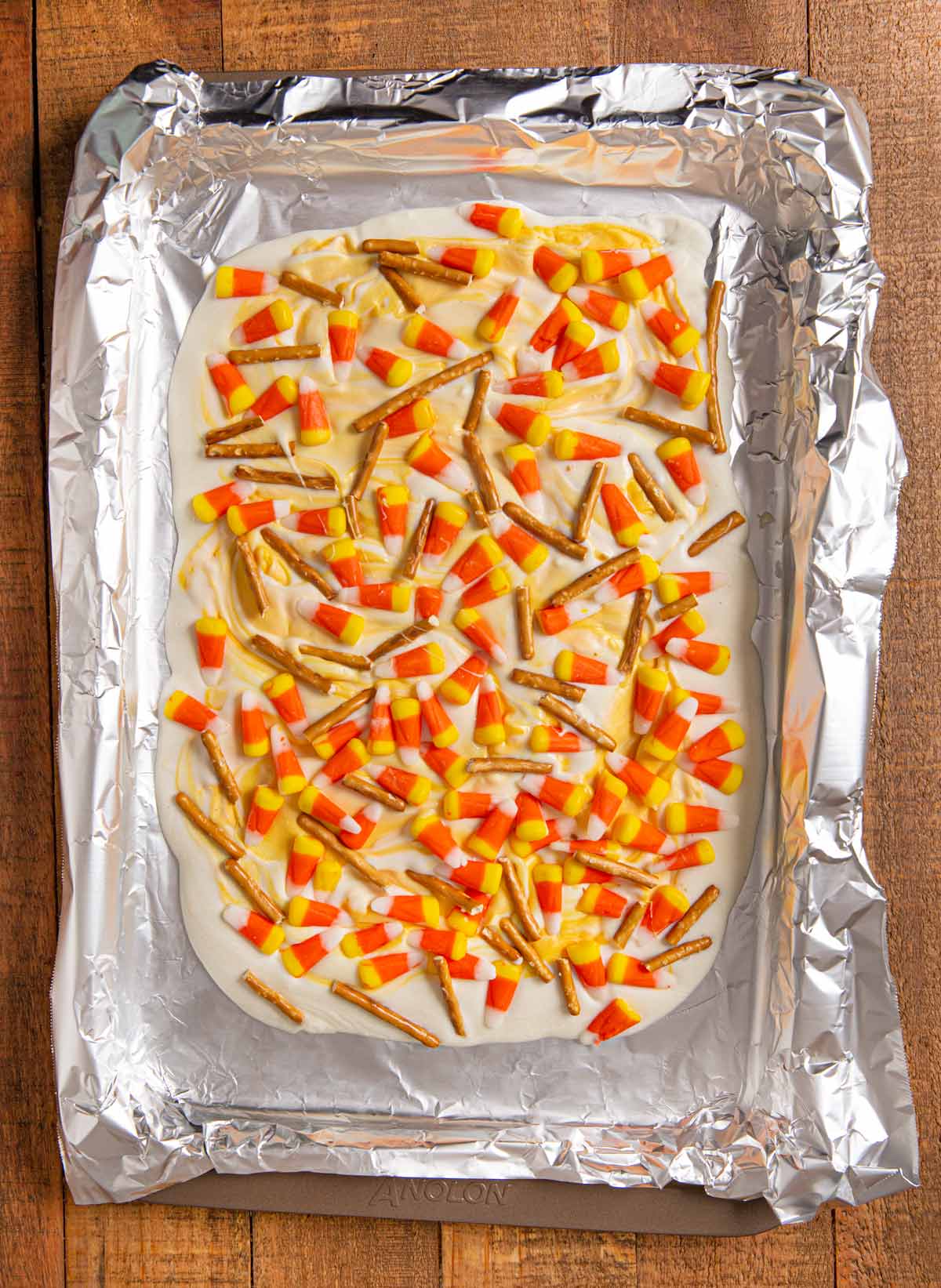 Candy Corn Bark in baking dish with foil