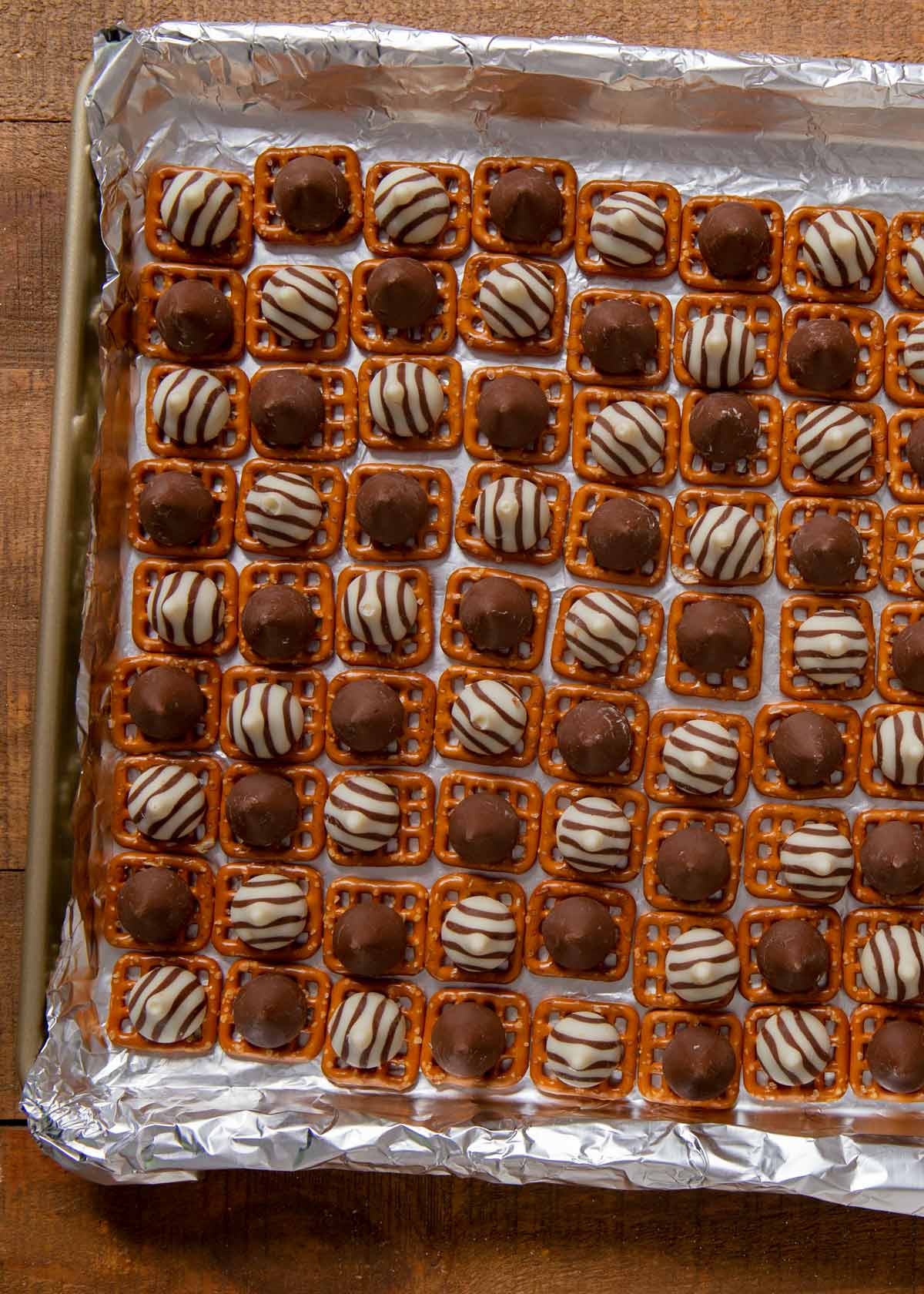 Candy Corn Pretzel Hugs pretzels and chocolate on baking sheet