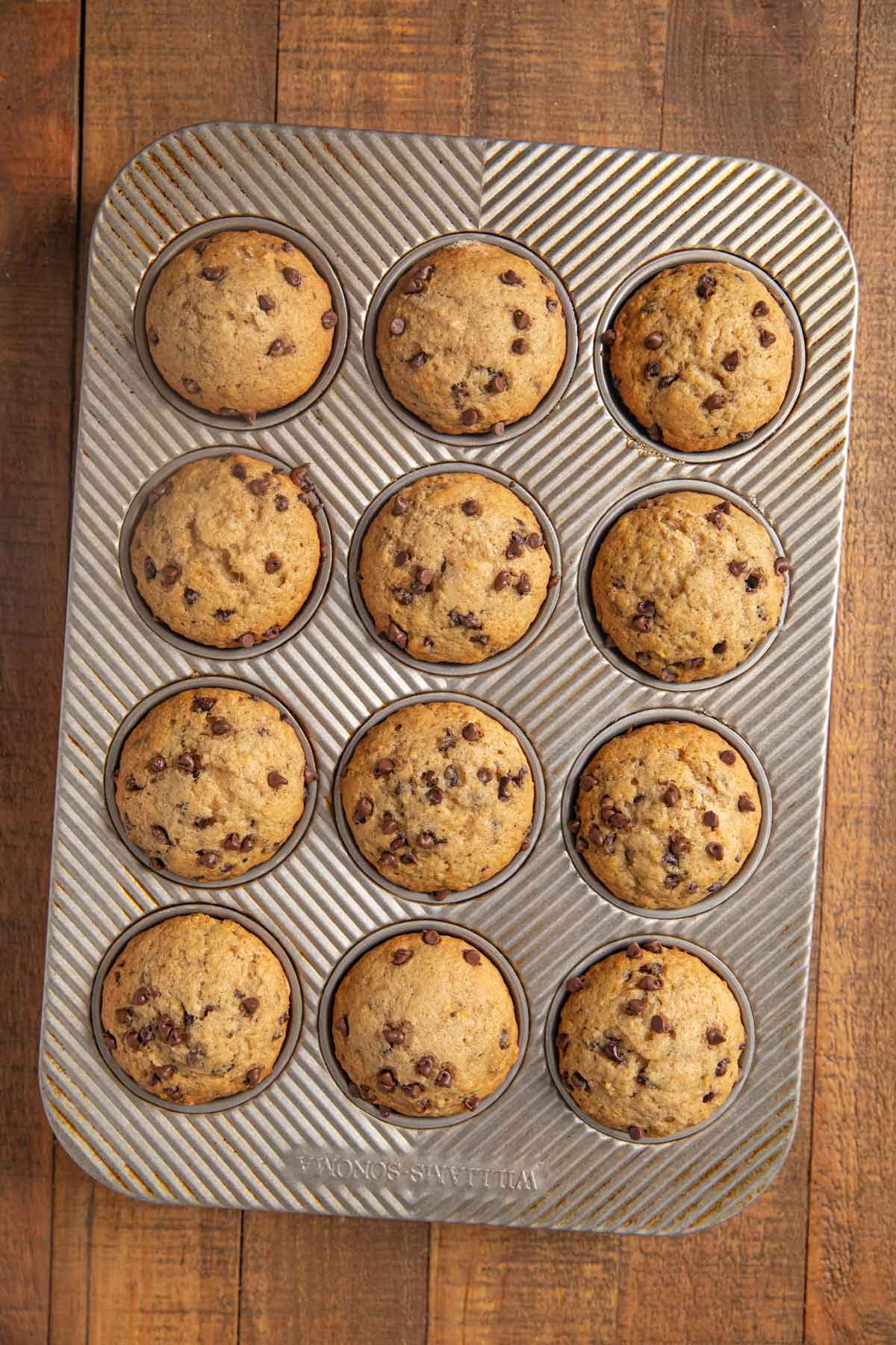 Chocolate Chip Banana Muffins in muffin tin, top-down