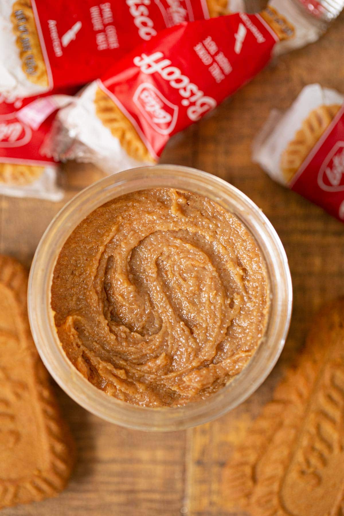 Cookie butter in jar with biscoff cookies around it