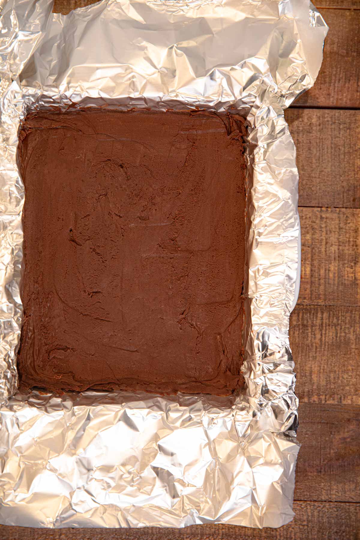 Dark Chocolate Orange Fudge in baking pan with foil