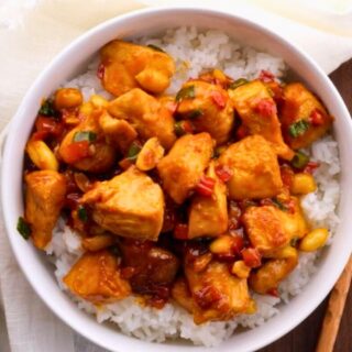 Chinese chicken dinner in a white bowl over rice