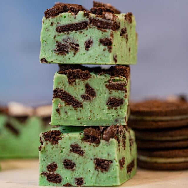 stack of Mint Oreo Fudge with Oreos in the background
