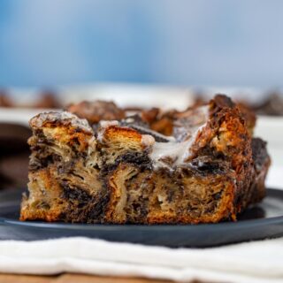 square slice of Oreo Croissant Bread Pudding on blue plate