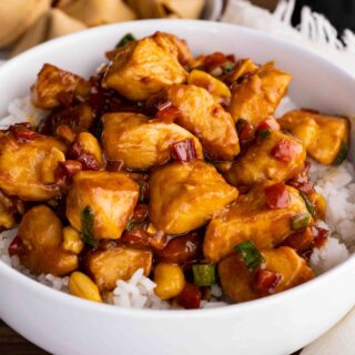 Kung Pao Chicken over rice in bowl close up
