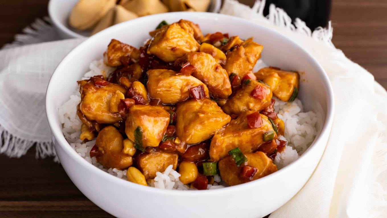Kung Pao Chicken over rice in bowl close up