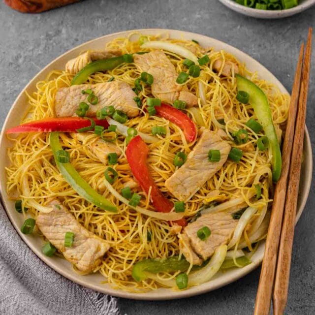 Singapore Noodles in bowl with chop sticks