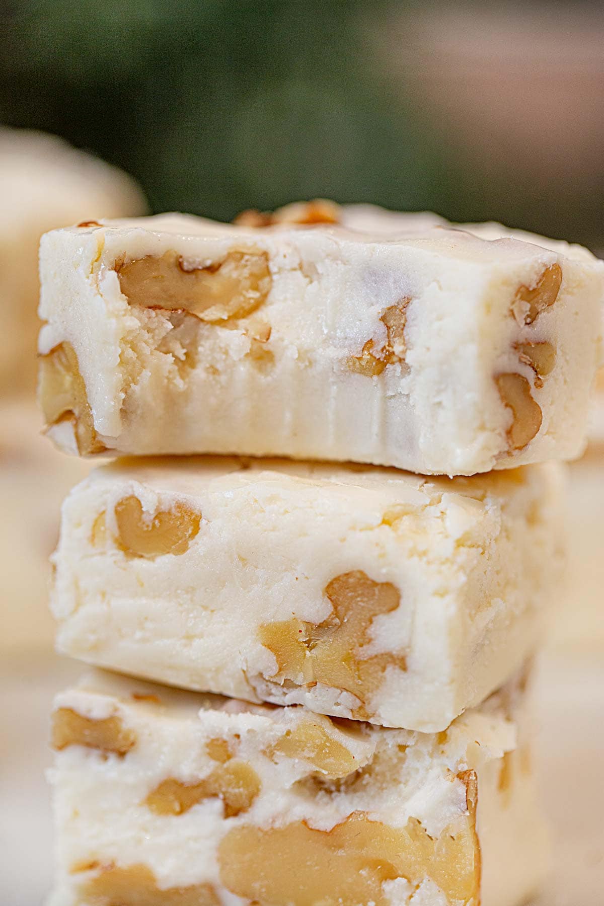 two bites of See's Vanilla Walnut Fudge in stack