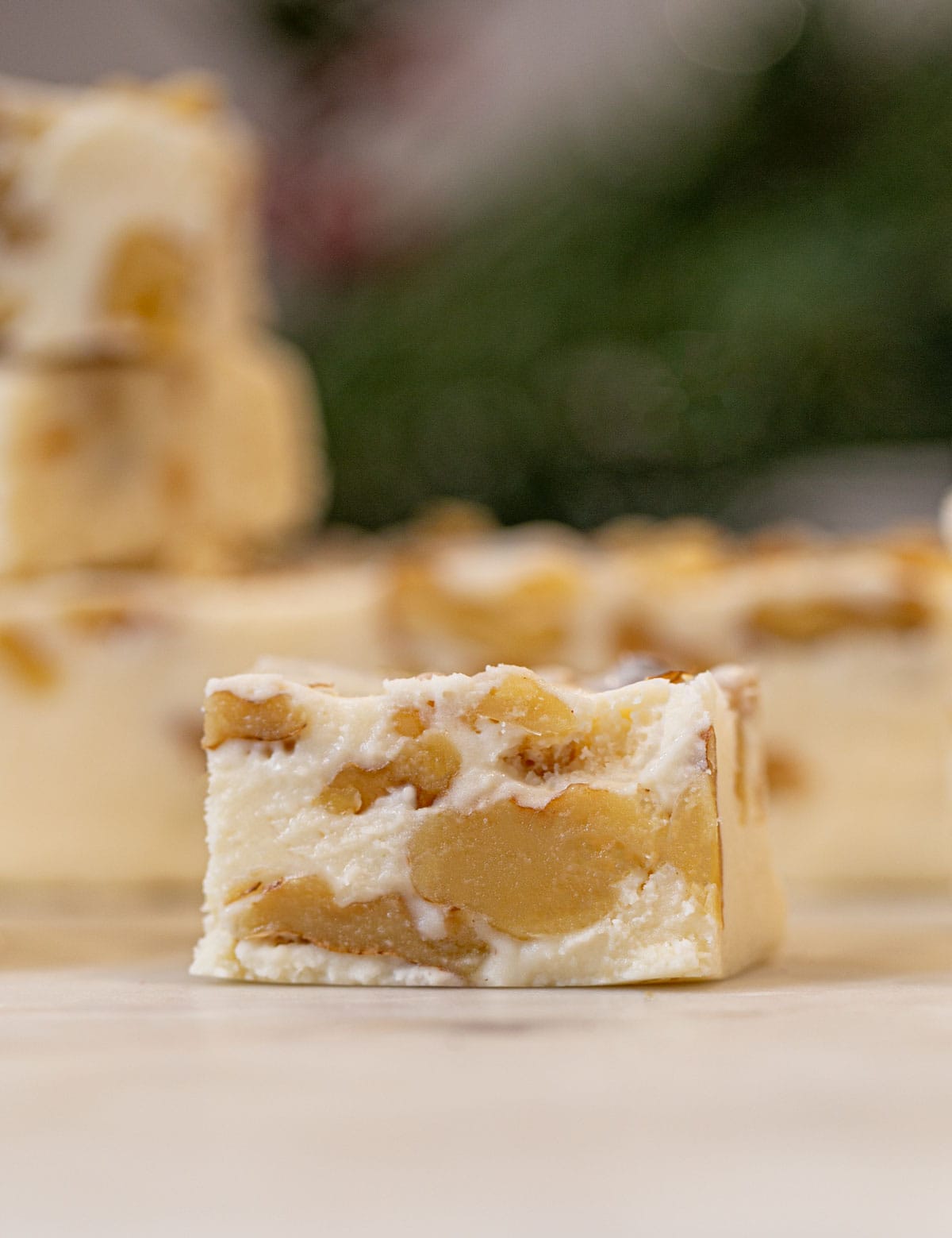 two bite of See's Vanilla Walnut Fudge on cutting board