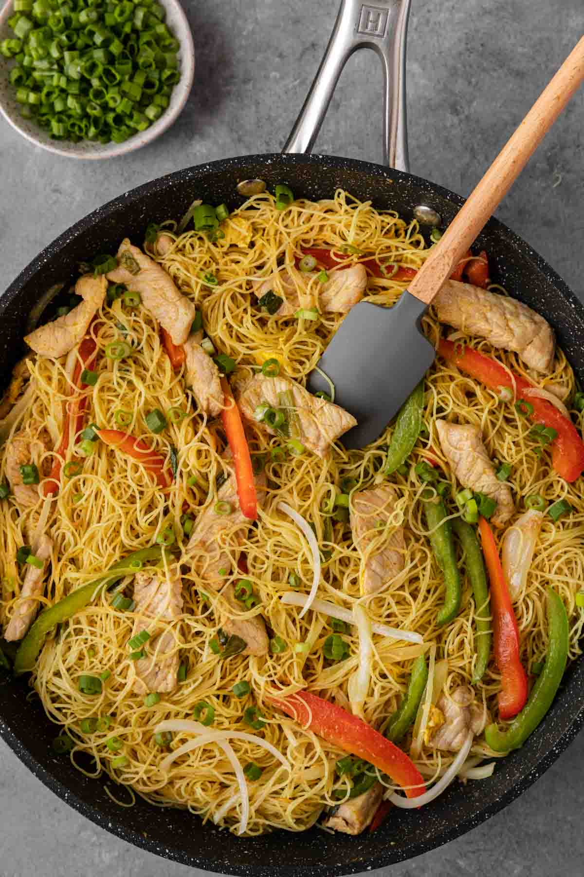 Singapore Noodles finished in wok with rubber spatula