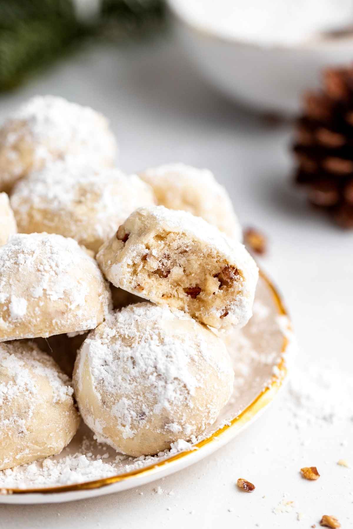 Snowball Cookies on serving plate with bite taken