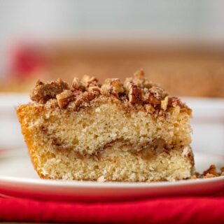 Sour Cream Coffee Cake cropped on white plate and red napkin