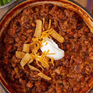 Taco Chili garnished with sour cream, cheese and Fritos