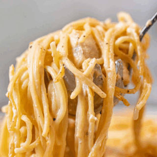 noodles and chicken on a ladle