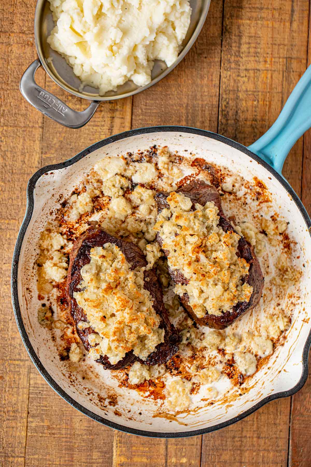 Blue Cheese Crusted Filet Mignon in skillet with mashed potatoes