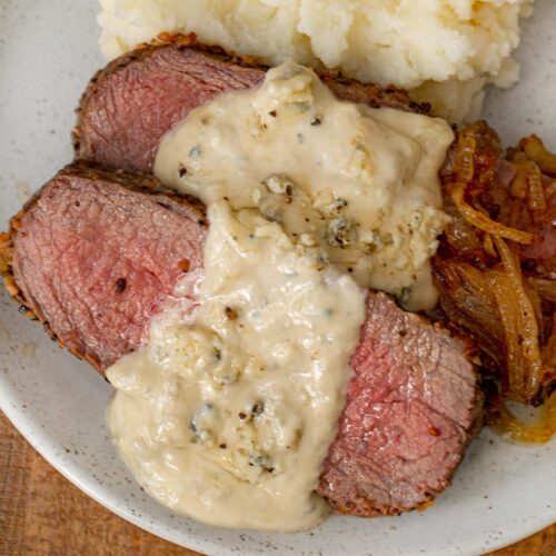 Sauce over steak on plate 1x1