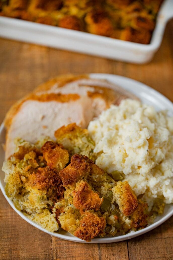Cornbread Dressing on plate with turkey and mashed potatoes
