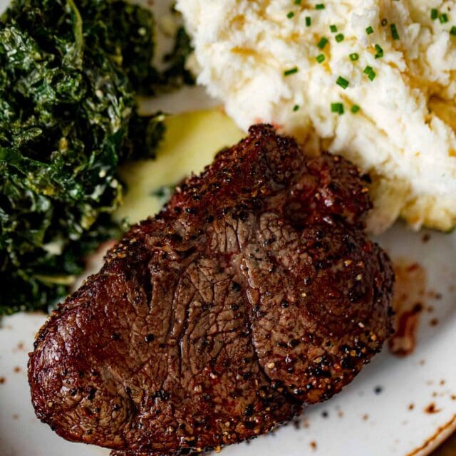 Filet Mignon on plate with mashed potatoes and spinach