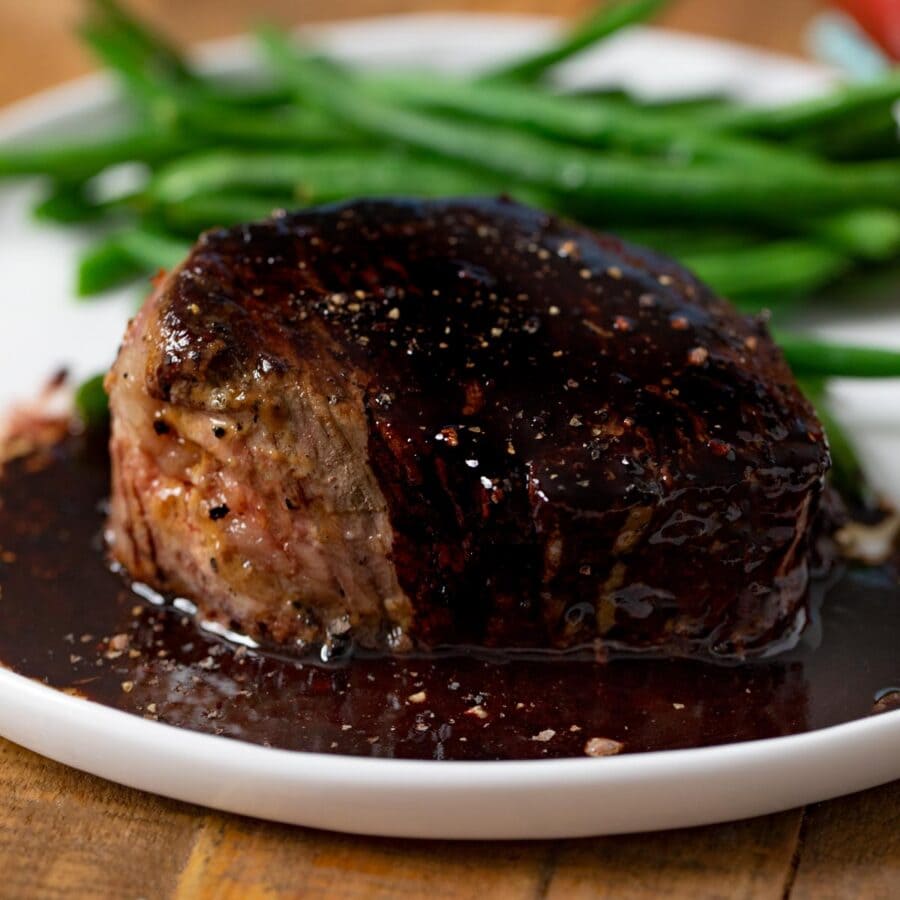 Filet with Red Wine Reduction on plate with green beans